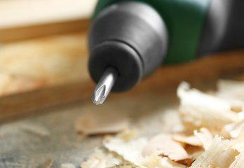 Poster - Screw-driving machine on table in carpenter's shop, closeup