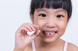 Leinwandbild Motiv Asian Chinese little girl holding her missing tooth
