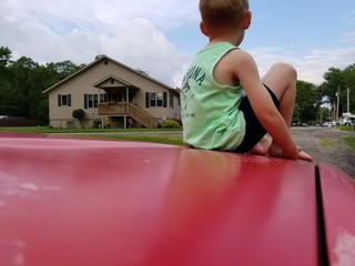 Daydreaming on the hood of Daddy's car