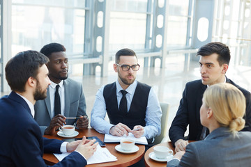 Sticker - Group of modern business people meeting in office building discussing work