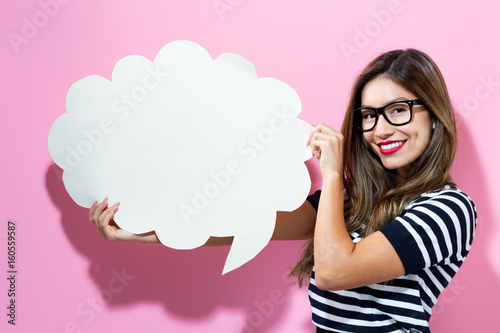 Young woman holding a speech bubble Canvas Print