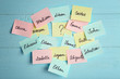 Paper stickers with different names on color wooden background. Concept of choosing baby name