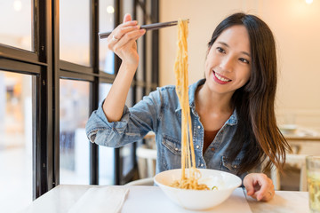 Poster - Asian Woman eating noodles in chinese restaurant