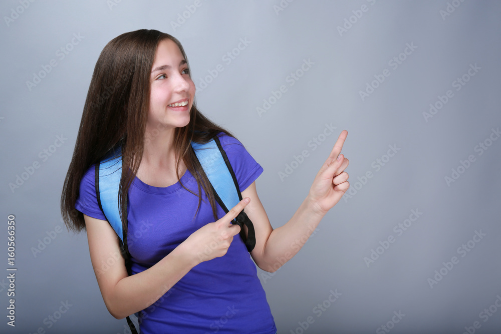 Cute pretty girl with schoolbag on color background