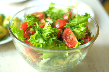 fresh vegetable salad with tomato, cucumber and salad frisee