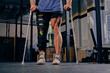 © Fxquadro - Injured bodybuilder's leg in bandage with crutches.