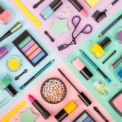 Wall Mural - set of professional decorative cosmetics, makeup tools and accessory on multicolored background. beauty, fashion and shopping concept. flat lay composition, top view