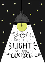 Hand Lettering You The Light Of The World, Made On The Star Background With Glowing Light Bulb.