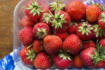 Juicy ripe strawberry on a vintage table