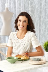 Poster - Happy woman having breakfast at home