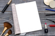 © gerasimov174 - Mock-up of a female magazine or catalog on a wooden table. Cosmetics is next, lipstick. Blank page or notepad on wood background. Blank page or notepad for mockups or simulations.