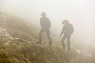 Hiking on mountain through fog