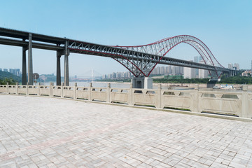 Canvas Print - empty floor with steel bridge in modern city