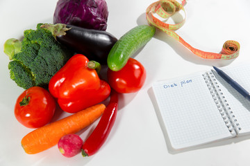 Vegetables, measuring tape and diet plan