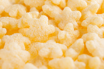 Yellow stars corn flakes closeup, cereals texture.