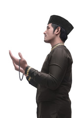 Wall Mural - Young asian muslim man praying with prayer beads