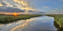 Sunset Over River In  Marshland Nature Reserve
