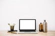 © Floral Deco - Blogger or freelancer workspace with front view of laptop with blank screen at white background. Minimalistic decorated home office desk.