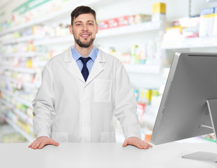 Sticker - Young handsome pharmacist standing at table on white background