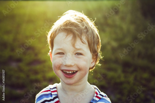Adorable Smiling Little Boy With Backlight Atmosphere Sun Light