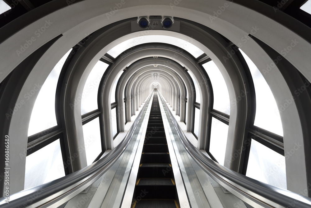 Futuristic tunnel and escalator of steel and metal, interior view. Futuristic background, business concept - obrazy, fototapety, plakaty 