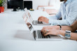 © bnenin - Working day in office. Businesspeople's hands typing on laptop keyboard in the office.