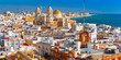 Aerial panoramic view of the old city rooftops and Cathedral de Santa Cruz in the morning from tower Tavira in Cadiz, Andalusia, Spain