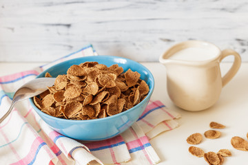 Wheat buckwheat bran breakfast cereal with milk in ceramic bowl