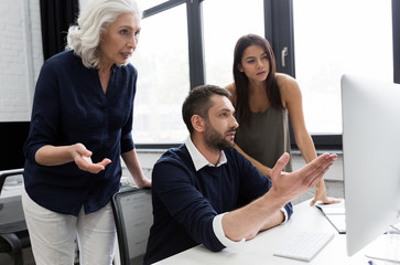 Wall Mural - Group of business people discussing financial plan at the table in an office