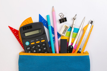 Student pencil bag or pencil case with school supplies for student on white background. Blue pencil box with school equipment for math class isolated on white background. School math equipment.