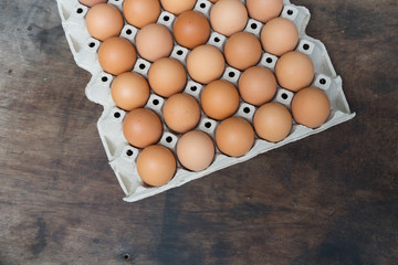 Wall Mural - Chicken egg on wooden background with copy space