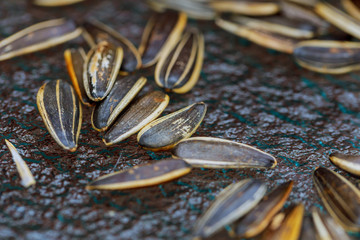 white sunflower seeds in glass jar. sunflower seeds on black background.