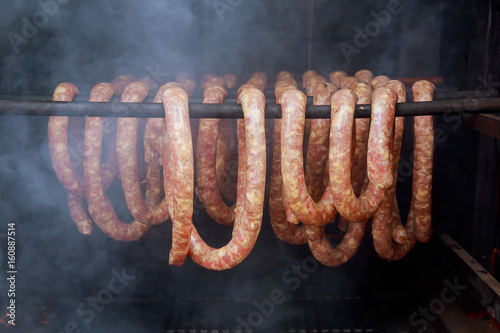 Fotografie, Obraz Homemade sausages in a traditional smoker