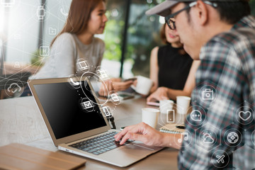 A asian man using laptop with IOT, internet of things sign and icon. Digital era or omni channel concept. Internet on everyday.