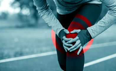 Poster - Athletic woman on running track touching hurt leg with knee injury