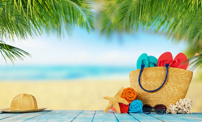 Tropical beach with accessories on wooden planks, summer holiday background.