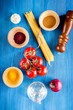 © 9dreamstudio - Food ingredients for Italian spaghetti on blue wooden desk background top view