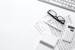 Business report preparing with calculator and glasses on white office background top view mock up
