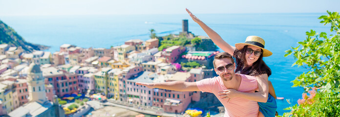 Happy family with view of the old coastal town background of Vernazza, Cinque Terre national park, Liguria, Italy ,Europe