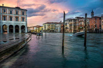 Panoramic view on famous Grand Canal among historic houses in Venice, Italy after rain at sunset