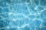 Fototapeta Do pokoju - Blurred natural background of blue water with bokeh and sun reflections
