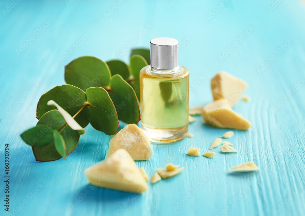 Beautiful composition with ingredients for cocoa butter lotion on table