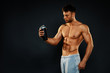 © djile - Attractive fitness man holding a bottle with protein shake