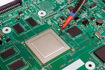 Soldering the video processor on an infrared soldering station. Electronics repair close-up