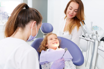 Wall Mural - Dentists examining little girl