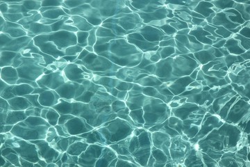 clear water with reflections from the sun a backdrop of clear water in a swimming pool reflected by 