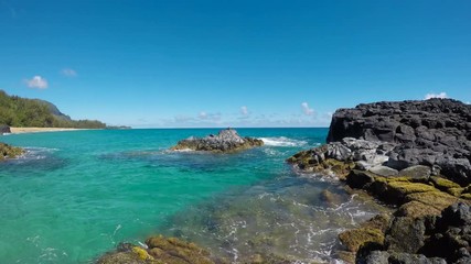 Wall Mural - Rocks frame the turquoise ocean off Lumahai Beach in Kauai in Hawaiian islands