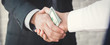 Businessmen making handshake with money in hands