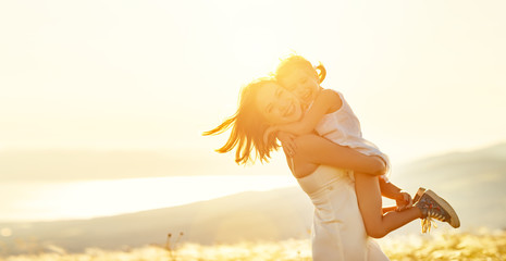 Poster - Happy family in summer outdoors. mother and child daughter hugs