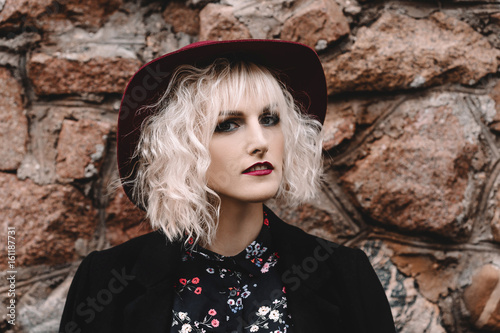 Beautiful Cute Blonde Girl With Curly Hair In A Hat And Black Coat